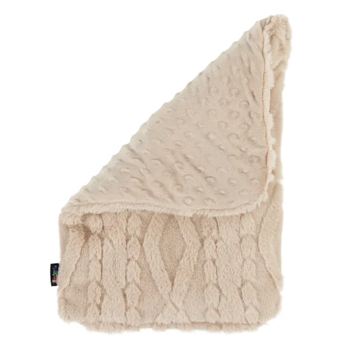 Cable knit faux fur weighted lap pad resting on a child's lap at a classroom desk