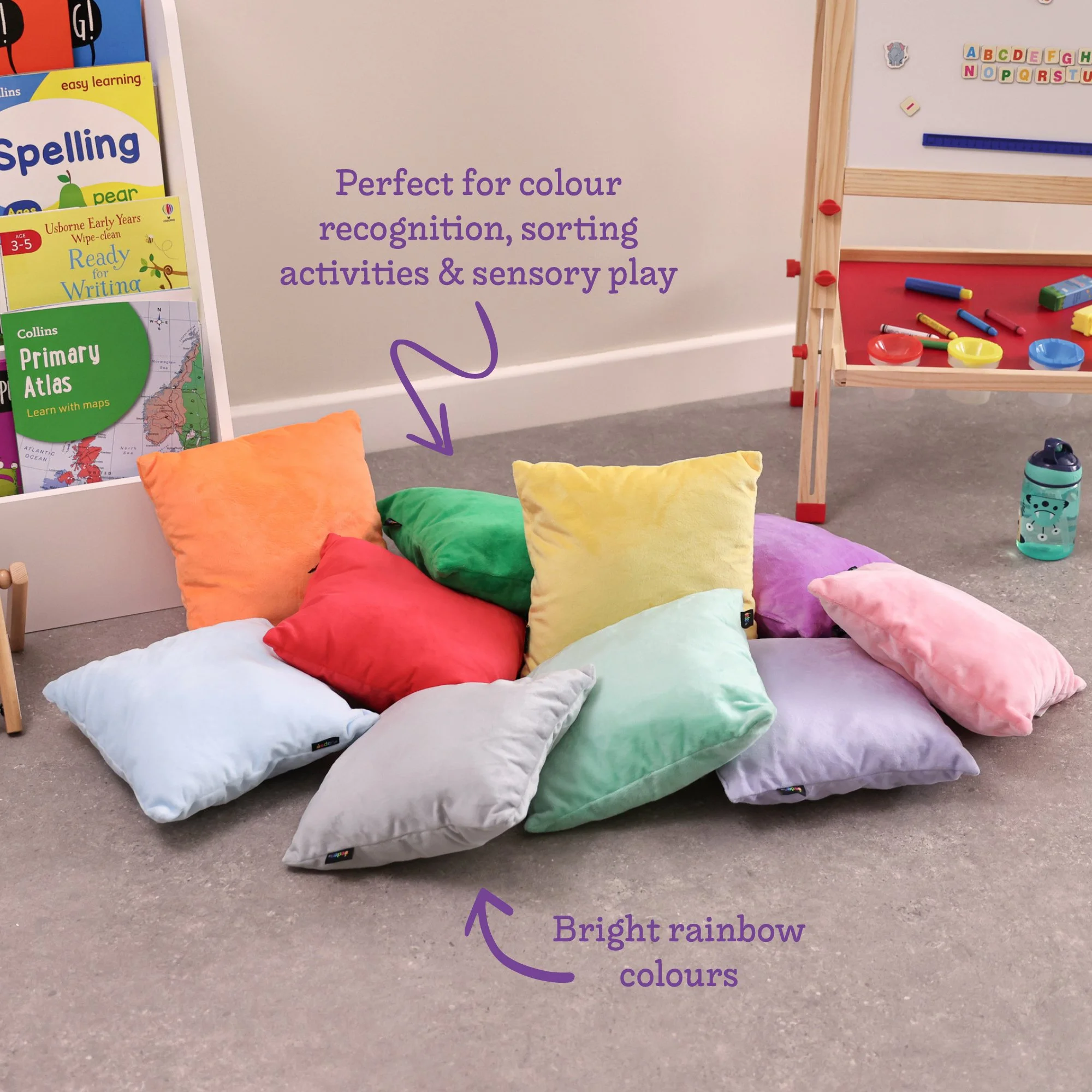 Pack of ten bright coloured fleece cushions arranged for a classroom story corner
