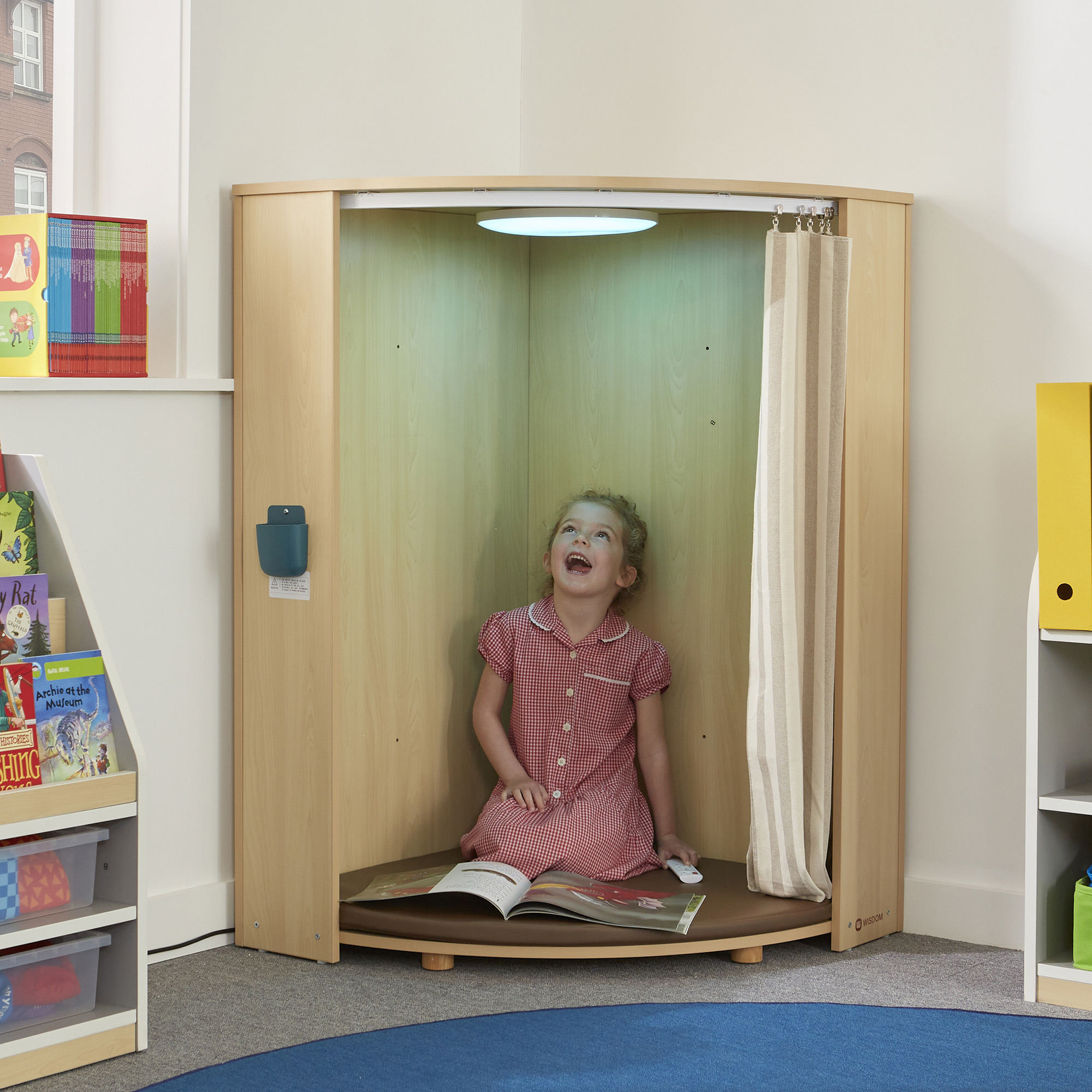 LED corner cabinet sensory den with cushioned seating and privacy curtain